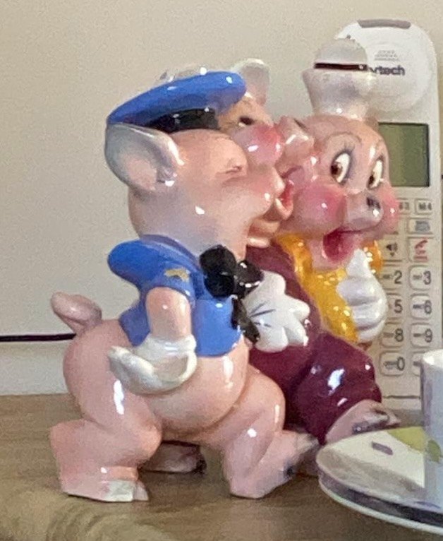 Roslyn&rsquo;s three ceramic pigs standing arm in arm